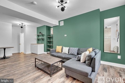 A living room with a grey couch and a coffee table.