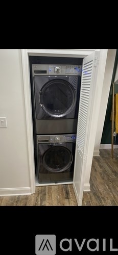 A washing machine is installed in a wall-mounted cabinet.