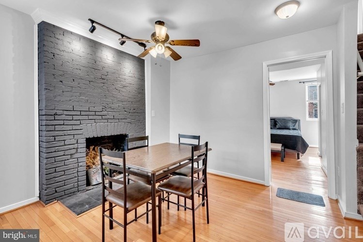 A room with a fireplace and a dining table.
