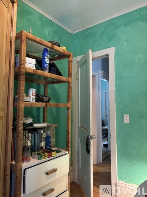 A kitchen with wooden floors and a white refrigerator.