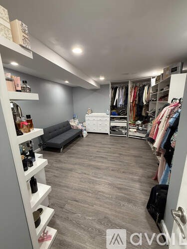 A room with a desk, computer, chair, and a window with curtains.