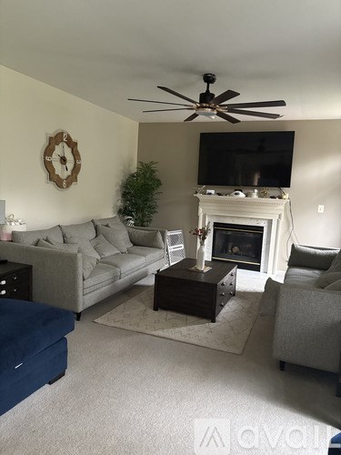 A bedroom with a bed, dresser, and ceiling fan.