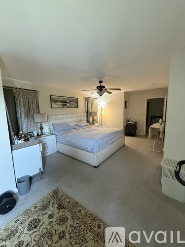 A bathroom with a tub, sink, and mirror.