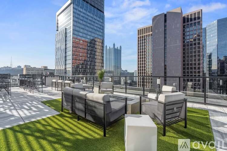 A modern outdoor seating area with a view of a city skyline.