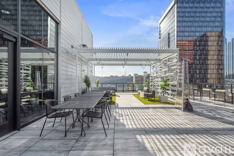 A patio with a table and chairs is surrounded by buildings.