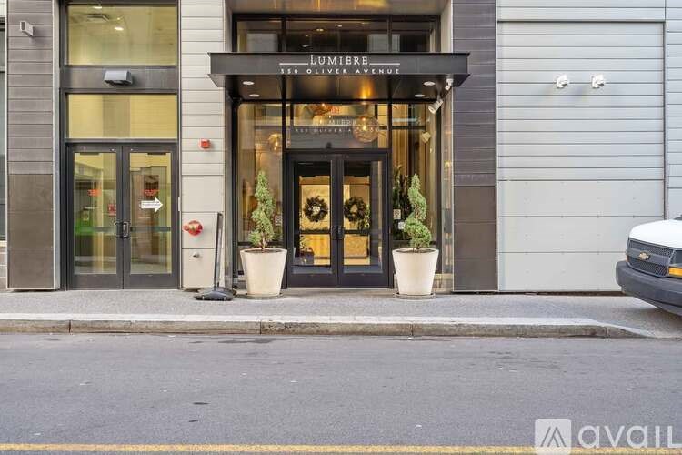 A storefront with a black awning and a glass door.