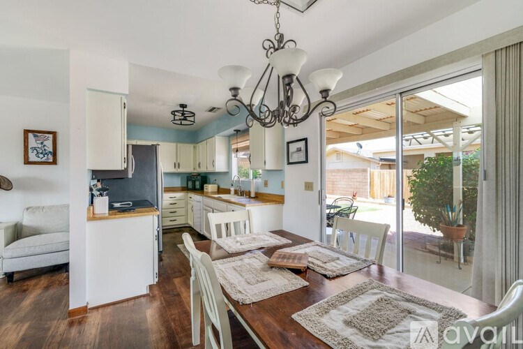 A dining room with a wooden table and chairs.