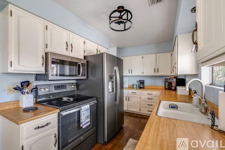 A kitchen with a stove, oven, and refrigerator.