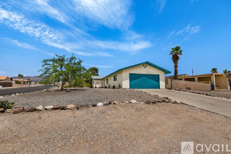 A house with a blue garage door is for sale.