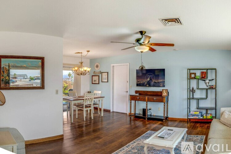 A living room with a dining table and chairs.