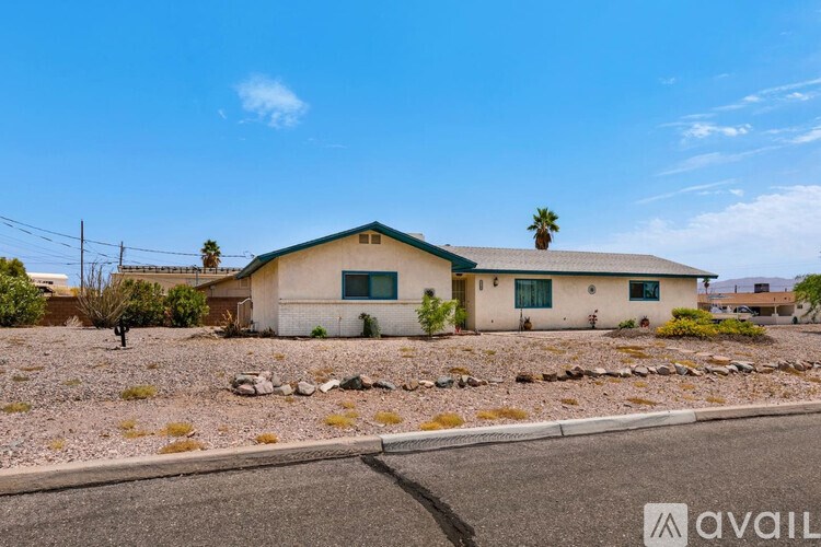 A house with a green roof and a palm tree on top is available for sale.