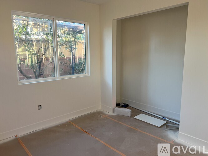 A room with a large window and a sliding door.