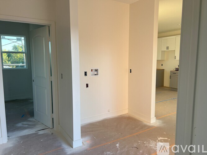 A room with a door and a wall socket.