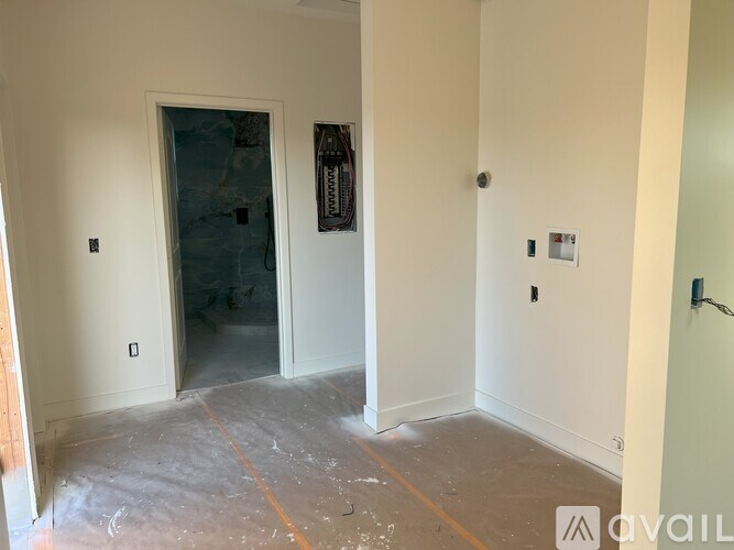 A room with a door and a wall socket.