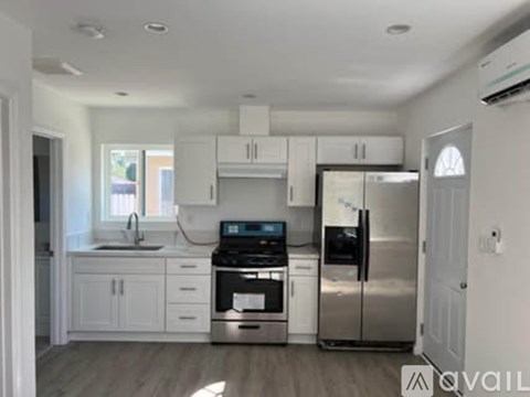 A kitchen with white cabinets and stainless steel appliances.