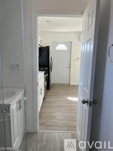 A bathroom with a white door and a white cabinet.