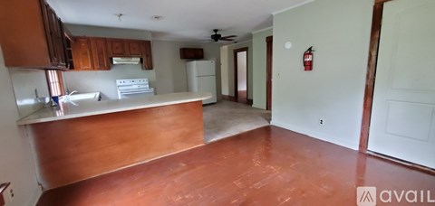 A kitchen with a wooden counter top and a white fridge.
