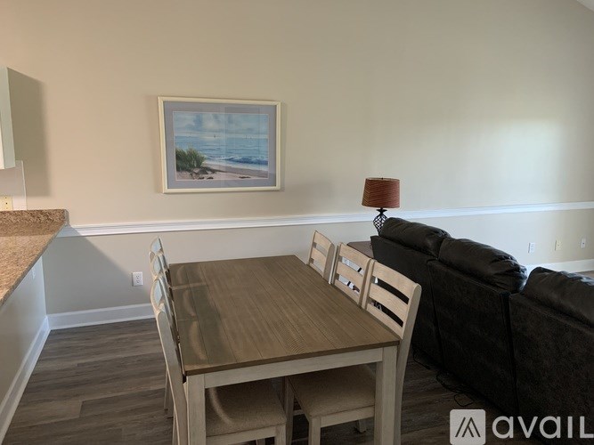A dining room with a wooden table and chairs.