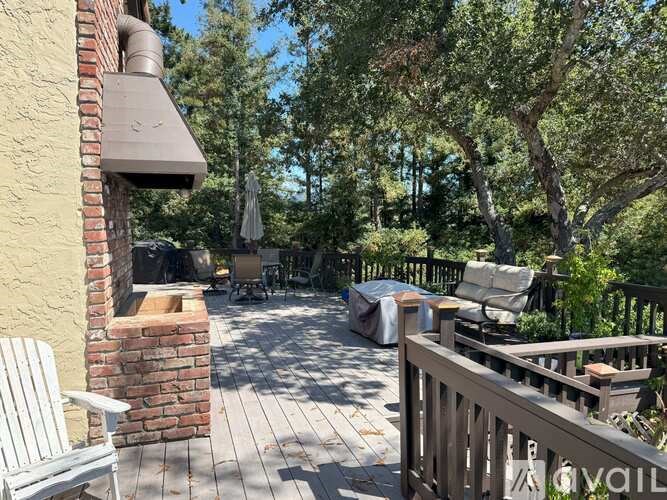 A patio with a white chair and a brick chimney.