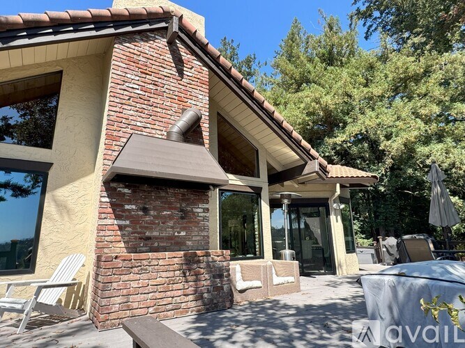 A house with a red brick chimney and a brown awning.