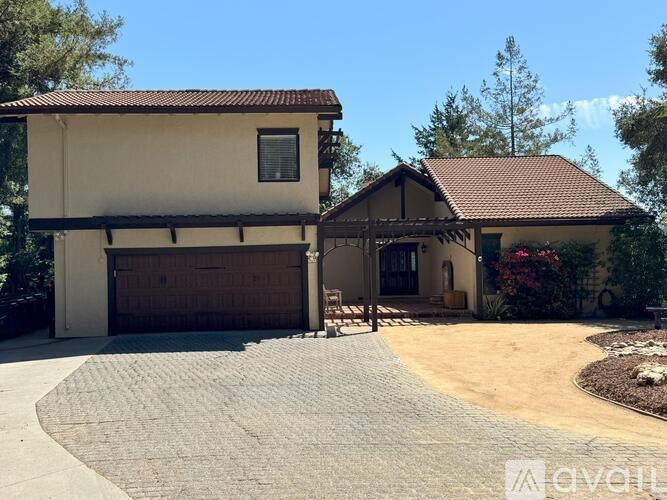 A house with a brown roof and a garage door.