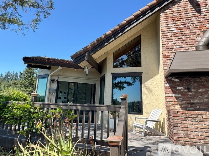 A house with a balcony and a chair.