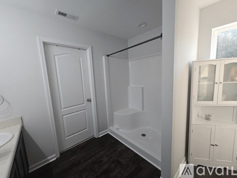 A white bathroom with a tub and sink.