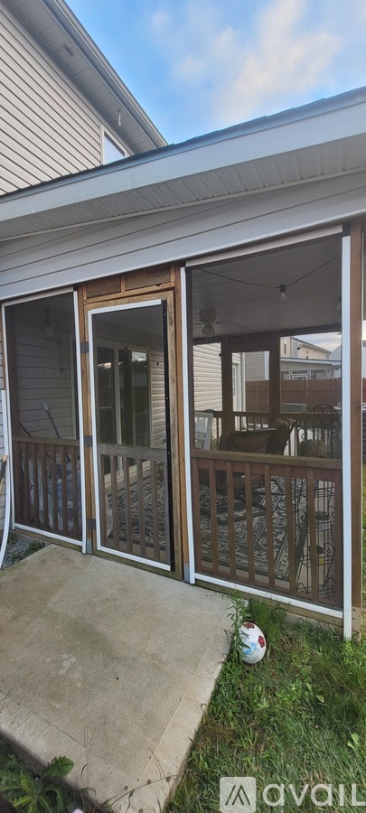 A patio with a sliding door and a glass railing.