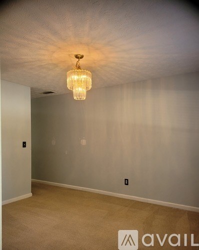 A room with a chandelier hanging from the ceiling.