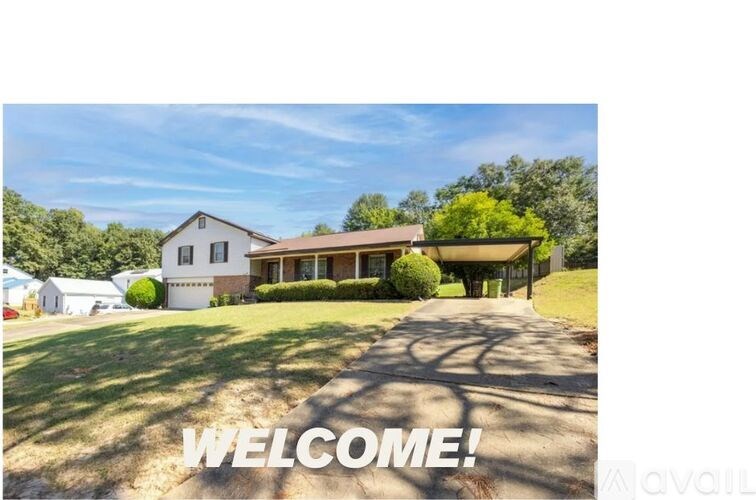 A house with a lawn and trees in the background with the word "WELCOME!" written on it.