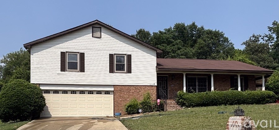 A house with a white siding and a brown roof is for sale.
