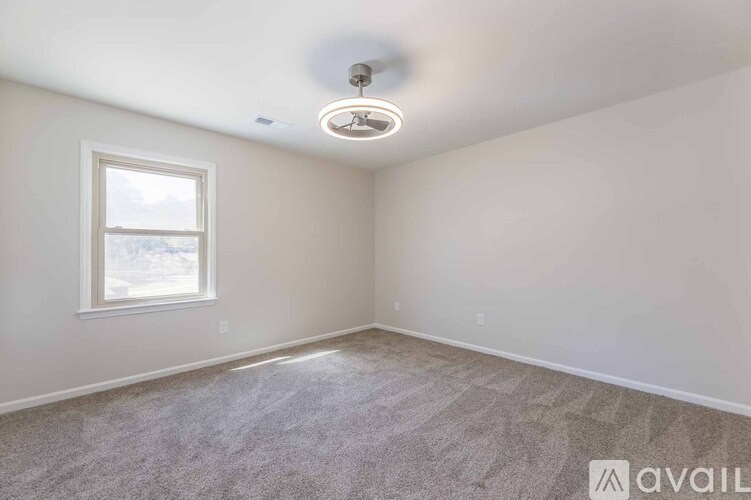A sunroom with a metal railing and a view of the outdoors.