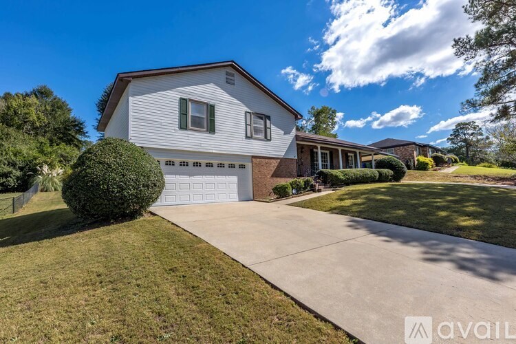 A house with a garage and a driveway is available for sale.