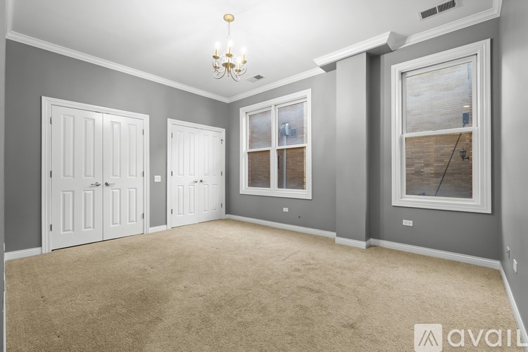 A room with grey walls and a carpeted floor.
