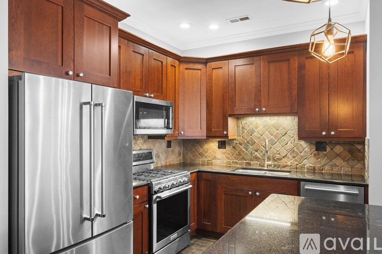A kitchen with wooden cabinets and stainless steel appliances.