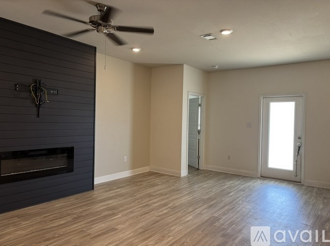 A room with a fireplace and a ceiling fan.