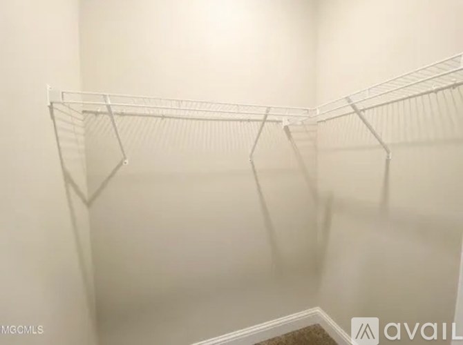Empty white shelves in a room.