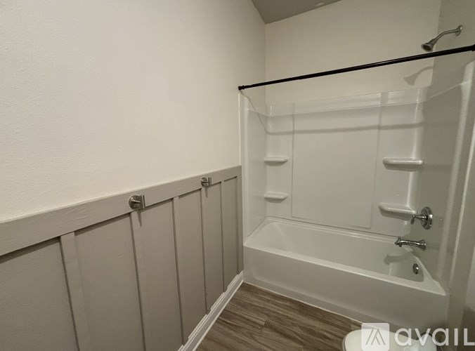 A white bathroom with a walk-in shower and a toilet.
