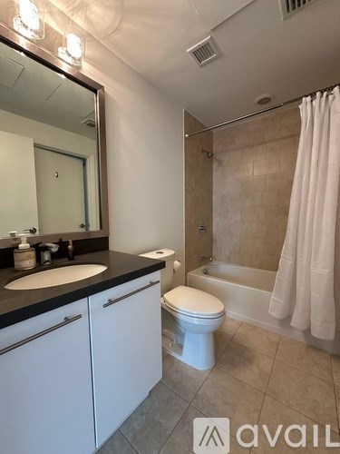 A bathroom with a sink, toilet, and bathtub.