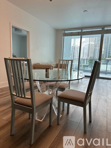 A dining room with a glass table and chairs.