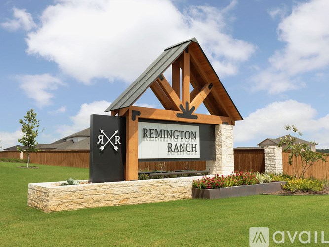 A sign for Remington Ranch is displayed in front of a building.