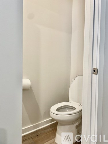 A white toilet in a small bathroom.