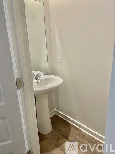 A white sink in a small bathroom.