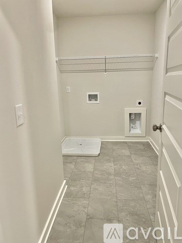 A bathroom with a toilet and a white door.