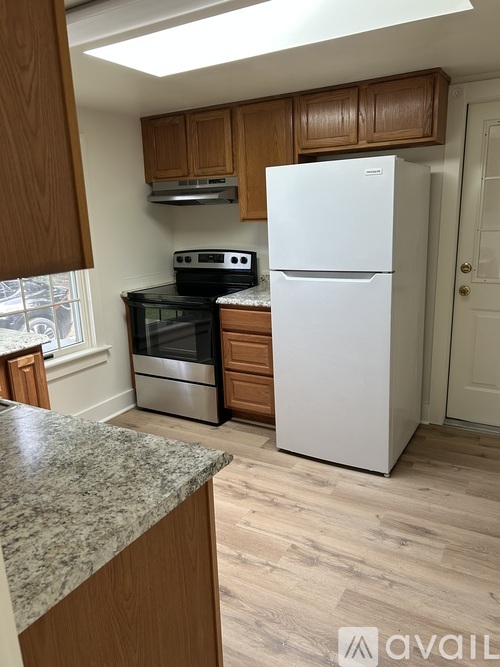 A kitchen with a white fridge and a stove top oven.