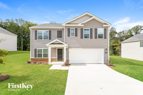 A grey house with a white garage door is for sale by FirstKey Homes.