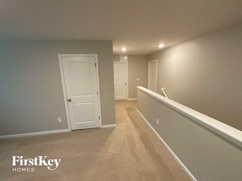 A room with a carpeted floor and white walls.