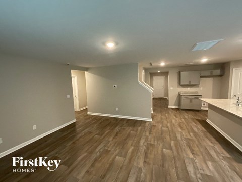A room with wooden flooring and a FirstKey Homes logo.