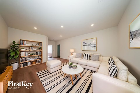 A living room with a white couch and a coffee table.