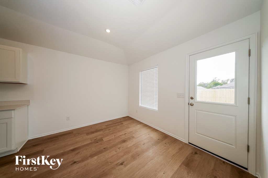 A room with wooden floors and a white door.